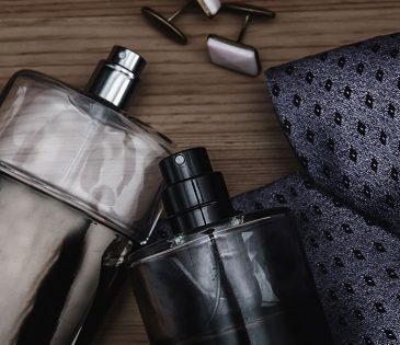 selection of colognes and a mens tie