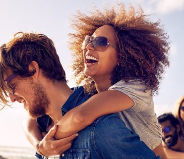 man and woman enjoy summer while wearing blue fragrances