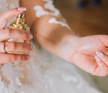 a june bride applies fragrance before her wedding