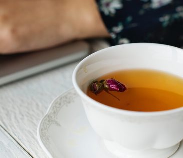 a cup of tea with a flower in it